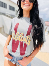 Load image into Gallery viewer, Woman wearing a gray t-shirt with 'Wildcats' printed on it, standing outdoors.