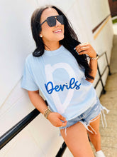 Load image into Gallery viewer, Woman wearing a light blue t-shirt with 'Devils' printed on it, standing against a white wall.
